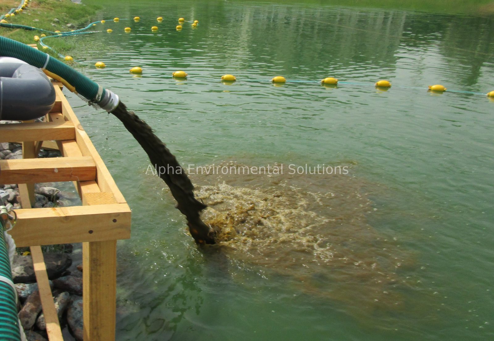 Hydraulic dredger pumping accumulated sludge from the bottom of an ornamental lake in the UAE
