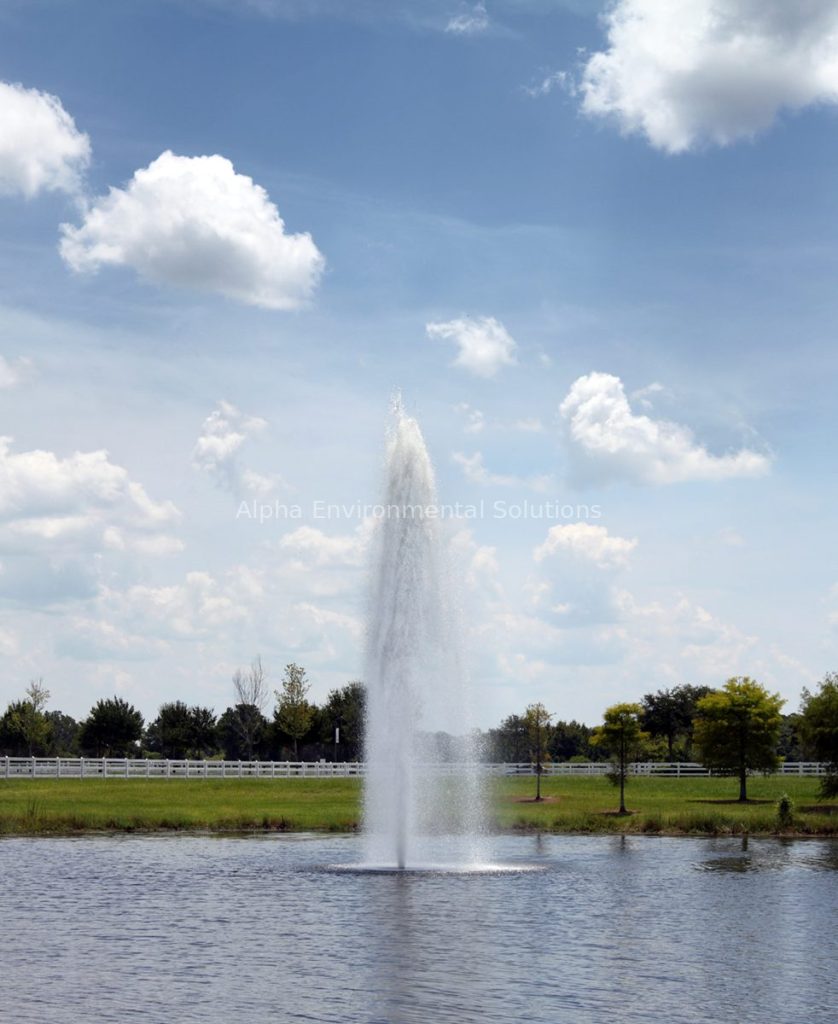 Floating fountain aerator adding oxygen and circulation to a community lake to control odour in the Middle East summer